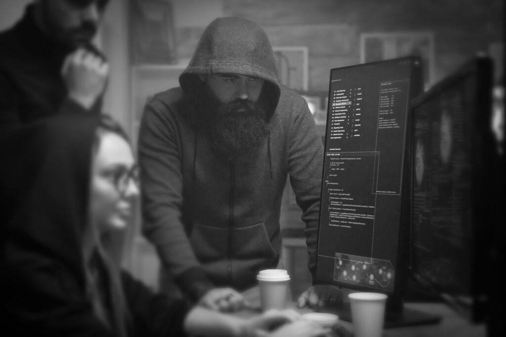 "Black and white photo of hackers at computers — symbolic of the website hacking challenge faced by McAllen photographer Abel Riojas."
