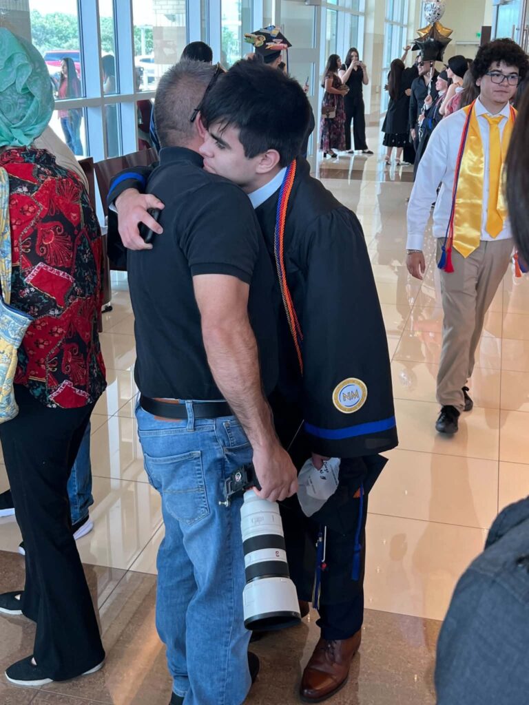 Father hugging son after Idea North Mission high school graduation